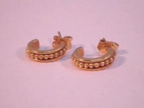 A pair of 18ct gold half hoop style earrings