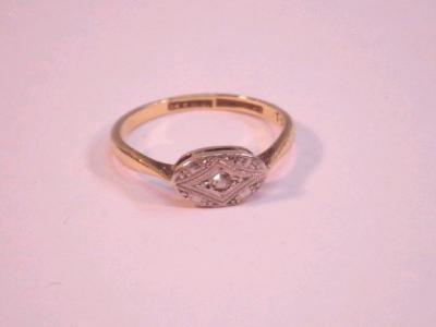 An Art Deco style plaque top ring set with a central small stone and diamond chips