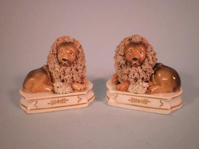 A pair of mid 19thC Staffordshire porcelain lion and lamb groups