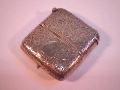 A silver vesta case with a half and full sovereign case in the base