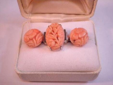 A pair of carved coral earrings and a similar dress ring