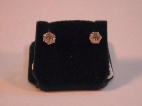 A pair of diamond solitaire ear studs