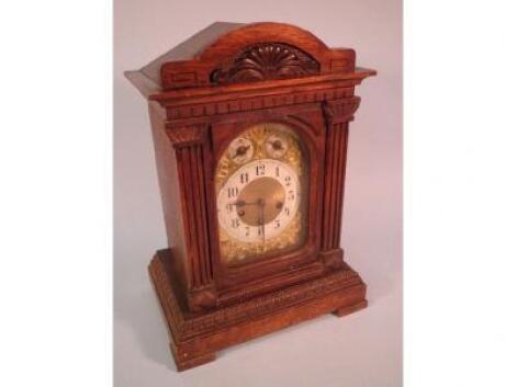 An early 20thC oak mantel clock