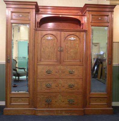 A Victorian satinwood and marquetry triple breakfront wardrobe