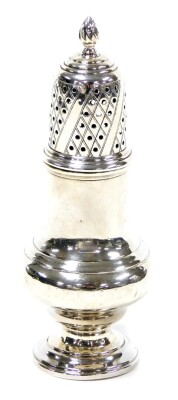 A George VI silver sugar shaker, with acorn finial top on baluster stem, on a stepped foot, Birmingham 1937, 3½oz, 16cm high.