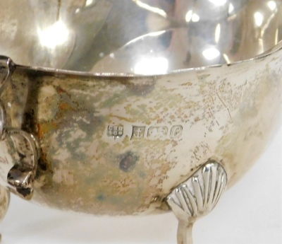 An Elizabeth II silver sauce boat, with fluted border, on rococo scroll handles, on tripod shell feet, Birmingham 1977, 4½oz. - 2