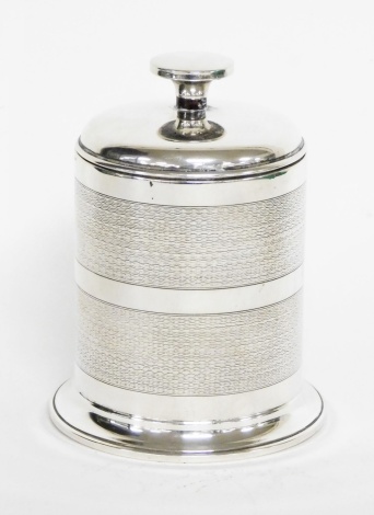 A George V silver cigarette dispenser case, with two row engine turned decoration, and glass interior, Birmingham 1923, 12cm high, 7½oz gross.