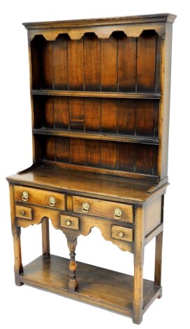 An oak dresser, in the 18thC style, with two plate shelf, the base with two long and three short drawers, above a pot board, 163cm high, 90cm wide, 36cm deep.