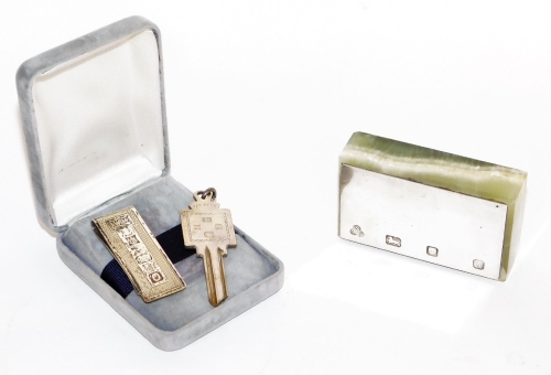 A small group of silverware, to include a silver topped and agate paperweight, London 1978, 8cm wide, 4cm deep, a later silver money clip and a silver key, Birmingham, weighable silver 1oz. (3)