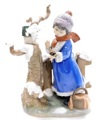 A large Lladro figure group, of a winter scene with young girl looking after birds, no. 5287, 28cm high.