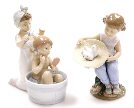 Two Lladro figure groups, to include a girl having a bath, with figure brushing hair no. 6457, 17cm high, and a figure of a girl with hat with two doves no. 6759, 17cm high (2).