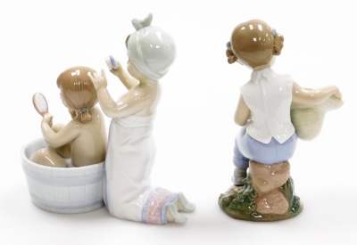 Two Lladro figure groups, to include a girl having a bath, with figure brushing hair no. 6457, 17cm high, and a figure of a girl with hat with two doves no. 6759, 17cm high (2). - 2