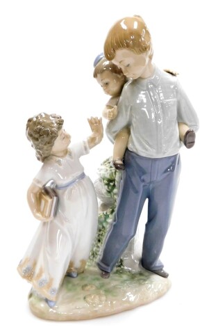 A Lladro figure group, of friends and family, with a boy having a piggyback, and girl with reading books no. 5702, 26cm high.