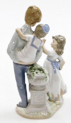 A Lladro figure group, of friends and family, with a boy having a piggyback, and girl with reading books no. 5702, 26cm high. - 2