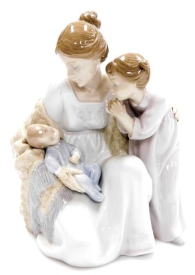 A Lladro figure group, of mother holding baby with child, no. 6939, 23cm high.