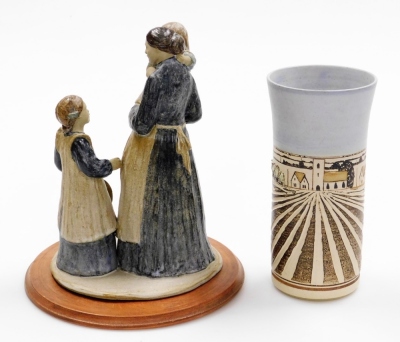 Two items of studio pottery, to include a studio pottery stem vase, signed Gough, and dated 95, of Fenland scene, with flowers, on a ribbed and flared body, 22cm high, together with a stoneware sculpture of lady carrying child talking to another figure, 2 - 2