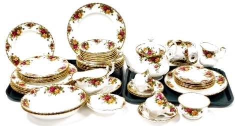 A Royal Albert Royal Country Roses part tea and dinner service, comprising gravy boat and saucer, soup bowls, side bowl, serving bowls, dinner plates, side plates, bread plates, six cups and saucers, teapot, milk jug, sugar bowl. (2 trays)