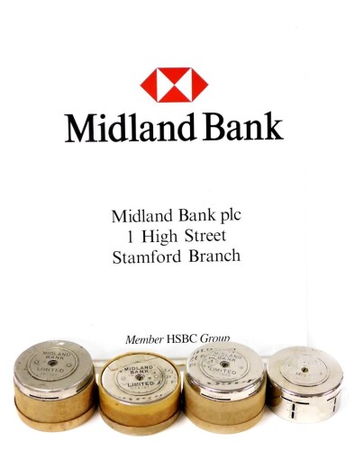 HSBC interest. The Midland Bank Stamford Branch sign, enamelled metal, and four Midland Bank Limited savings tins. (5)