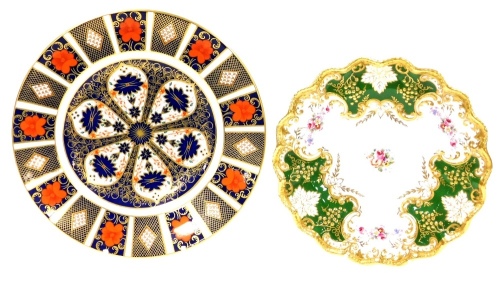 Two Royal Crown Derby Plates, to include a Royal Crown Derby Imari pattern plate numbered 1128, and a Royal Crown Derby green gilt and floral posies pattern plate. (2)