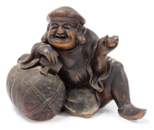 A Chinese terracotta figure of a seated man, 24cm high, 26cm wide.