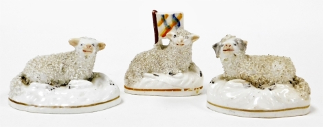 Three Staffordshire sheep ornaments, 7cm high, 27cm high, 18cm high. (3)
