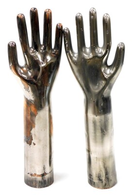 A set of silvered metal hand displays, possibly glove formers, 37cm high.