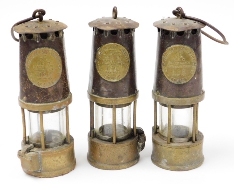 Three Miner's lamps, each for Eccles numbered 104, 131, and 196, one lacking carry hook, 25cm high. (3)