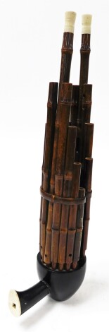 A Sho Sheng musical instrument, with handle.