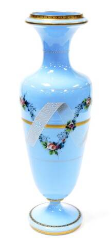 A Victorian blue opaque glass vase, with applied floral decoration and ribboning, on gilt border, 50cm high.