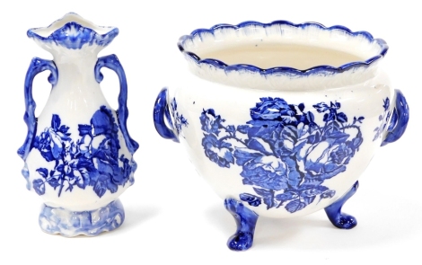 Two Staffordshire ironstone ornaments, to include a rose bowl on tripod feet, with floral decoration and blue bordering, 22cm high, and a two handled vase, 26cm high. (2)