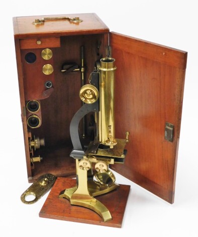 A 19thC brass cased microscope, with various altering lenses, 36cm high, in a fitted case.