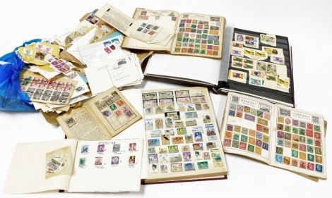 A group of stamps, to include two albums of world and used stamps, postage stamp albums, loose stamps, etc.