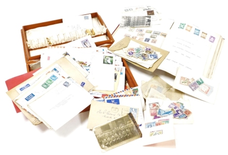 An album of world stamps together with various loose stamps, the album containing used world stamps, Denmark, Dominica, France, Finland, Germany, Holland, Hungary, and India, together with a box of loose envelopes with used postage stamps. (a quantity)