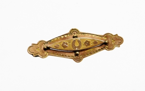 An Edwardian bar brooch, the central diamond shaped panel set with leaves and horseshoes, an engraved backing stamped AJC, possibly silver gilt but unmarked, 5cm wide, 4.4g all in.