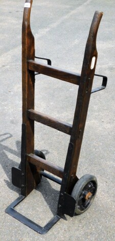 A vintage sack truck, bearing label for Slingsby, on wooden frame with metal supports.