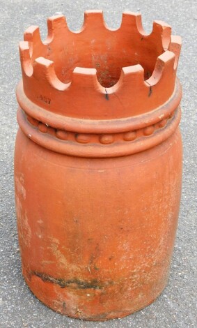 A terracotta chimney pot, with crown top finial on a domed body, 60cm high.