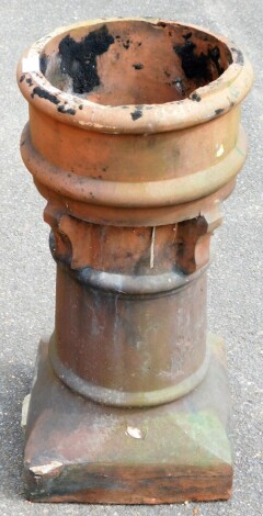 A Victorian terracotta chimney pot, the top AF, with pierced overall side and splay design, 70cm high.