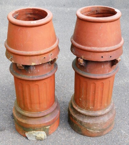 A pair of Victorian terracotta chimney pots, with domed and pierced top and Corinthian column base on circular foot, 82cm high. (2)