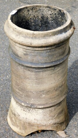 A reconstituted stone chimney pot, with two flare rimmed body, 57cm high.