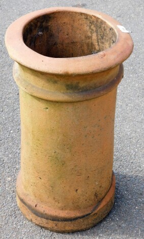 A terracotta chimney pot, with ribbed and flared top design, 60cm high.