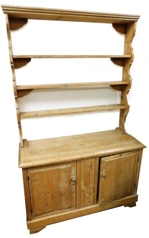 A Victorian pine kitchen dresser, with applied three shelf plate rack, on sideboard base with two cupboards, 184cm high, 118cm wide, 45cm deep.