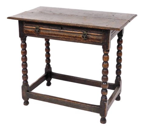 A late 18th/early 19thC oak side table, with single drawer with cutlery compartment conversion, on bobbin turned supports and rectangular framed base adapted, 77cm high, 91cm wide, 54cm deep.