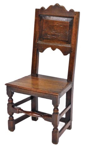 A late 17th/early 18thC oak side chair, the moulded back with clover type design on rectangular back panel with solid dowel seat, on X frame base, 101cm high, 46cm wide, 35cm deep.