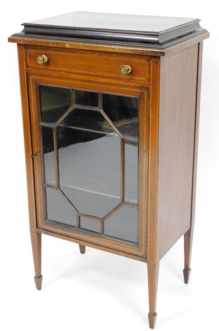 An Edwardian mahogany display cabinet, the canted top with single drawer above astragal glazed door, with marquetry banding on tapered supports, 108cm high, 59cm wide, 40cm deep. (AF)