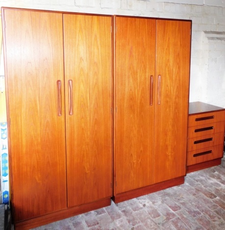 A G-plan teak bedroom suite, comprising two two door wardrobes and a four drawer chest, the wardrobes 174cm high, 85cm wide, 58cm deep, the chest 72cm high, 71cm wide, 44cm deep. (3)