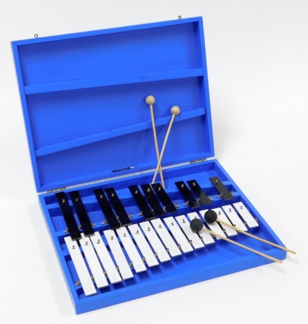 A cased xylophone, in painted blue case with four sticks, 38cm wide, 30cm deep.