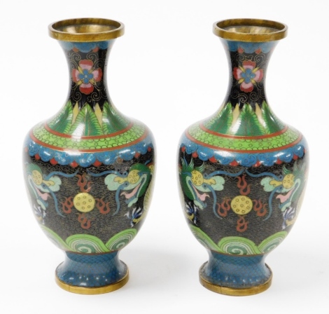 A pair of cloisonnÃ© vases, each decorated on a blue and black ground with dragons, 23cm high. (AF)