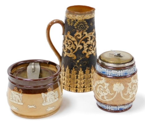 A group of Doulton and other stonewares, to include a Doulton Lambeth biscuit barrel, with a later lid with bead decoration, on a silver rim, 12cm high, a Doulton Slaters patent milk jug, 20cm high, and a Royal Doulton tobacco jar, with detailing of figur