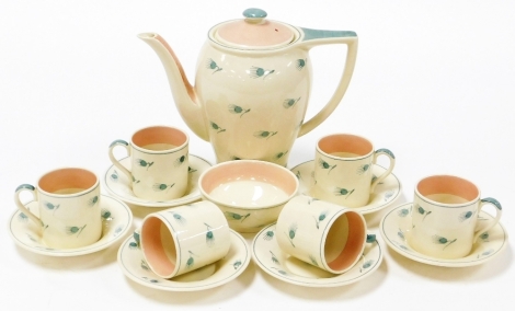 A Susie Cooper part coffee service, comprising six coffee cans and saucers, coffee pot and a sugar bowl.