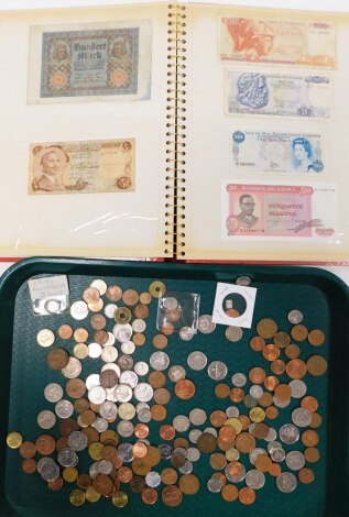 Various coins and bank notes, to include world coins, Euros, tokens, etc., an album containing bank notes, to include £1 state of Jersey, £1 Guernsey, $2 Barbados, United Arab Emirates and other bank notes. (1 tray and 1 book)